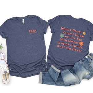 May include: A navy blue t-shirt with the text "PARA PROFESSIONAL" on the front and the text "When a flower doesn't bloom, you fix the environment in which it grows, not the flower." on the back. The text is in a pink and orange font with flower illustrations.