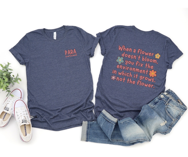 May include: A navy blue t-shirt with the text "PARA PROFESSIONAL" on the front and the text "When a flower doesn't bloom, you fix the environment in which it grows, not the flower." on the back. The text is in a pink and orange font with flower illustrations.