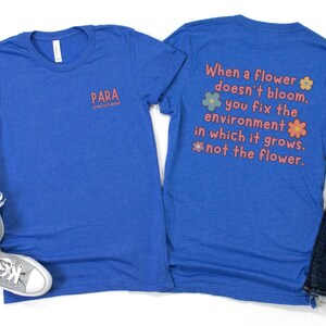 May include: Two blue t-shirts with a quote about flowers and the environment. The front shirt has the text "PARA professional" on the left chest. The back shirt has the text "When a flower doesn't bloom, you fix the environment in which it grows. not the flower."