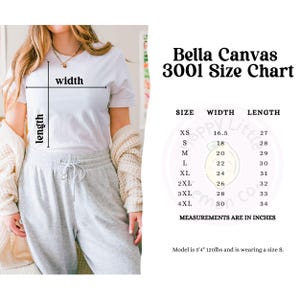 May include: A white Bella Canvas 3001 t-shirt size chart with measurements in inches. The chart lists sizes XS to 4XL, with corresponding width and length measurements. A person is wearing a white t-shirt. The model is 5'4" and 120lbs, wearing a size S.