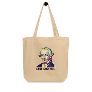 May include: Beige tote bag featuring a colorful pop art portrait of Immanuel Kant with the phrase "KANT TOUCH THIS" printed below. The bag has long handles and is made of a canvas-like material.