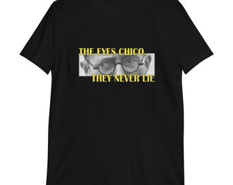 May include: Black t-shirt with a yellow graphic of a man's eyes and the text "THE EYES CHICO, THEY NEVER LIE."