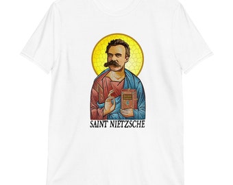 May include: White t-shirt with a colorful illustration of a man with a mustache holding a book. The text "SAINT NIETZSCHE" is printed below the illustration.