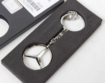 Llavero oficial MERCEDES-BENZ Bruselas Keyring, Plata B66957516 o Oro B66953741 NUEVO con embalaje de regalo