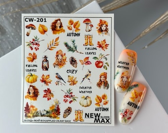 Puede incluir: Una hoja de calcomanías para uñas con temática otoñal. Las calcomanías presentan imágenes de hojas, calabazas, pájaros y mujeres. El texto "AUTUMN" aparece varias veces en la hoja. El texto "NEW SLIDER MAX" también aparece en la hoja.