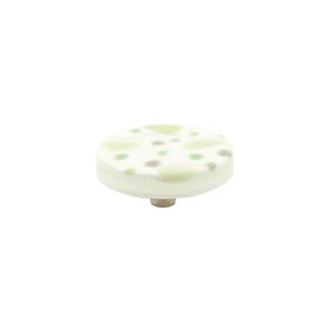 May include: A round, off-white cabinet knob with a decorative top. The top features a pattern of light green and gray dots. The knob has a silver-colored metal base. Ideal for furniture and home decor.