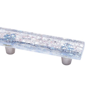 May include: A rectangular glass cabinet pull with a textured, iridescent finish. The pull has two silver metal mounting brackets.