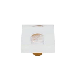 Peut inclure: Bouton de porte carré en verre avec une base en métal doré. Le verre est transparent avec un léger reflet iridescent.