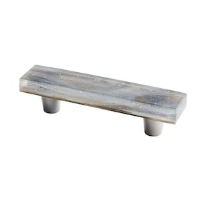 May include: A rectangular glass cabinet pull with a silver finish and a mottled, cloudy, white and gray pattern. The pull has two round, silver knobs.