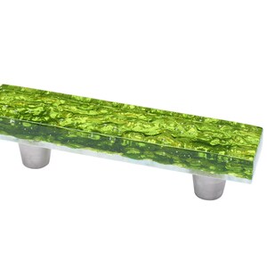 May include: A green glass cabinet pull with a textured surface and silver metal mounting hardware.