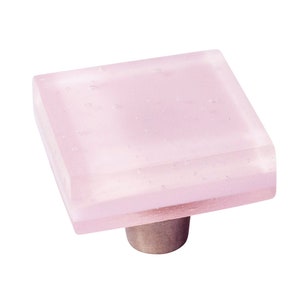 May include: Square pink glass cabinet knob with a silver base.
