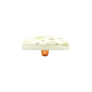 May include: A white ceramic cabinet knob with a green and brown speckled pattern. The knob has a copper base.