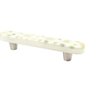 May include: A white ceramic cabinet pull with a green and brown speckled pattern. The pull has two silver metal knobs.