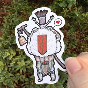 May include: A sticker featuring a cartoon character with a brush for a head, a bell, and a hammer. The character has a white body, a red shield, and is holding a staff. A red heart is next to the character.