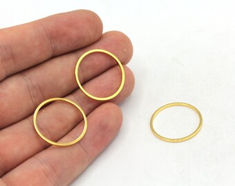 May include: Three gold-colored metal rings of different sizes. The rings are smooth and have a shiny finish.