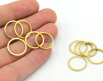 May include: A set of ten gold-colored metal jump rings. The rings are approximately 1 inch in diameter and are arranged in two piles.
