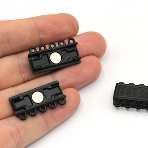 May include: Three black magnetic clasps for jewellery making. Each clasp has five loops and a magnetic closure.