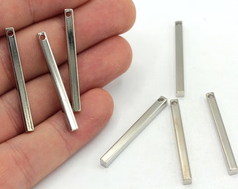 May include: Seven silver metal bar pendants with a small hole at the top for attaching to jewelry or other crafts.