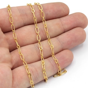 May include: A gold chain necklace with a delicate oval link design.