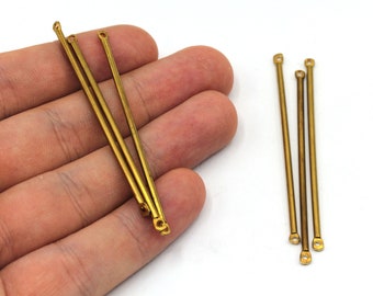 May include: Five gold-colored metal rods with rounded ends. The rods are approximately 1.5 inches long.