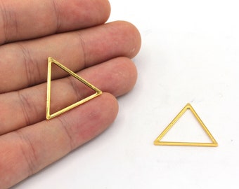 May include: Two gold triangle shaped metal frames. The frames are open and could be used for jewellery making or other crafts.