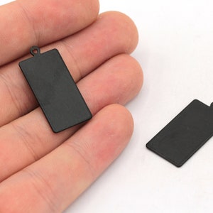 May include: Two black metal rectangular tags with a hole at the top. The tags are blank and ready to be personalized.