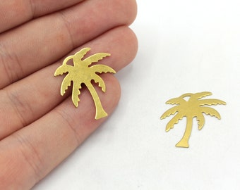 May include: Two gold-colored metal palm tree charms. The charms are cut out in the shape of a palm tree with a trunk and fronds.