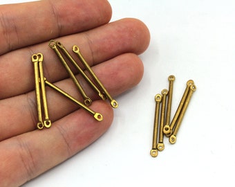 May include: A group of 10 gold-toned metal connector pieces with loops on each end. The pieces are arranged in two groups, one group of five and one group of five.