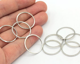 May include: A set of six silver jump rings, perfect for jewelry making or crafting projects.