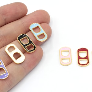 May include: Assortment of colorful metal slider buckles with gold trim. The buckles are in various colors, including black, white, light blue, pink, red, and yellow.