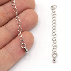 May include: Two silver extender chains with a teardrop-shaped end piece.
