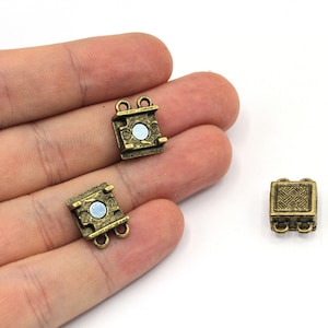 May include: Three antique gold-toned metal clasps for jewelry making. Two of the clasps have a magnetic closure and one has a traditional clasp.