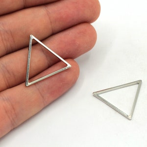 May include: Two silver triangle shaped metal frames. The frames are open and have a smooth, polished finish.