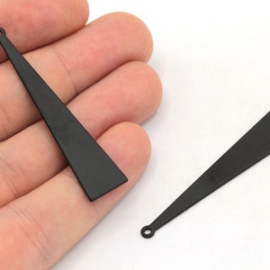 May include: Two black metal triangle shaped earring charms with a small loop at the top.