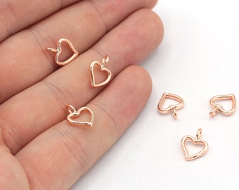 May include: Six rose gold heart-shaped charms with a jump ring for attaching to jewelry or crafts.