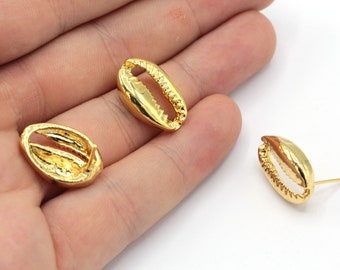 May include: A pair of gold-tone shell-shaped earrings. The earrings are made of metal and have a smooth, polished finish.