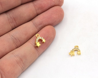 May include: Two gold-tone charms shaped like a crescent moon with two stars. The charms are decorated with clear sparkling rhinestones.