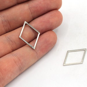 May include: Two silver diamond-shaped metal frames. The frames are open and have a smooth, polished finish.