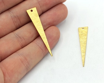 May include: Two gold-colored metal triangle pendant charms with a textured surface and a small hole at the top.