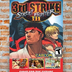 May include: A Street Fighter III 3rd Strike video game poster. The poster features illustrations of characters Ryu and Ken, with the game's logo at the top. The bottom of the poster reads "FIGHT FOR THE FUTURE".