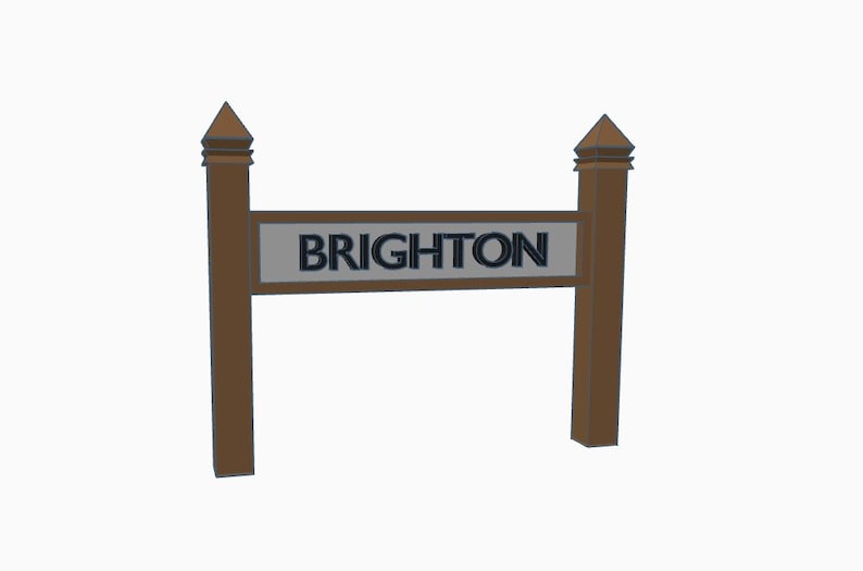 May include: A wooden sign with a pointed top on each side. The sign reads "BRIGHTON" in black letters on a gray background.