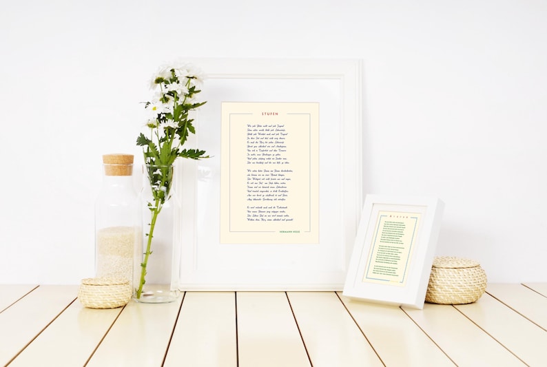 May include: Two white picture frames with a poem printed inside. The poem is titled "Dover." The frames are on a white wooden surface with a vase of white flowers and a small woven basket.