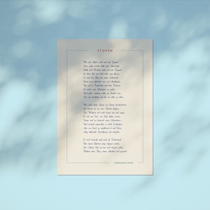 May include: A vintage-style print of a poem titled "Stufen" by Hermann Hesse. The poem is written in German and is printed on a cream-colored background with a blue border.
