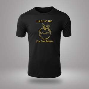 May include: Black t-shirt with a gold graphic of an apple with the text "House of Eris" and "KALLISTI FOR THE FAIREST" on it.