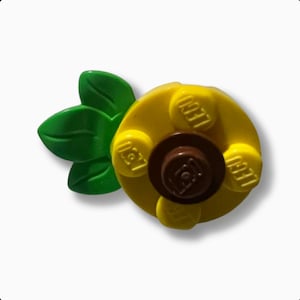 May include: A yellow LEGO pineapple with green leaves and four LEGO bricks with the word "LEGO" printed on them.