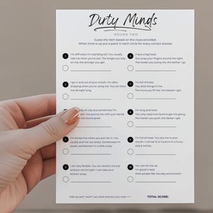 May include: A white card with the title "Dirty Minds" and clues for a game. The card is held by a hand with manicured nails. The game card has a list of clues and circles for answers.
