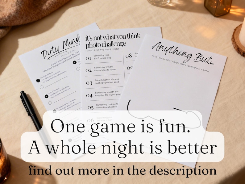 May include: Three white paper game sheets with black text, including "Dirty Mind," "It's Not What You Think Photo Challenge," and "Anything But." A black pen lies on the table. The text overlay reads: "One game is fun. A whole night is better."