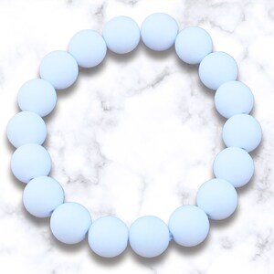 May include: A light blue silicone bracelet with round beads.