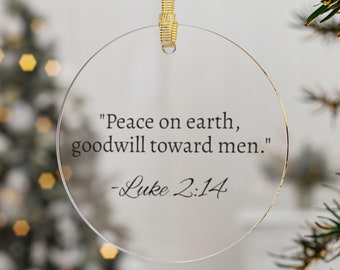 May include: A clear round Christmas bauble with the text "Peace on earth, goodwill toward men." - Luke 2:14 printed on it.