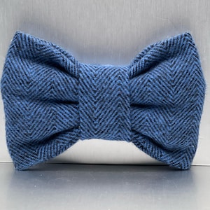 May include: A blue and black herringbone patterned bow tie.